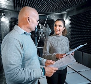 Two people talking in an emc test chamber