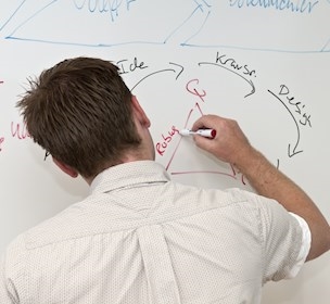 Man writing on whiteboard