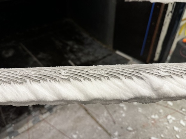 Overhead power line with ice build-up in climatic wind tunnel