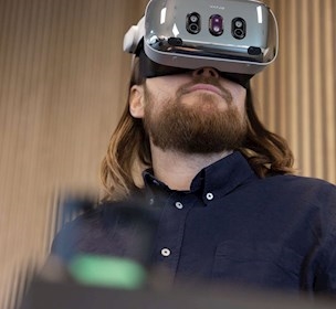 Marine pilot wearing Varjo XR-4 headset for remote maritime simulation training