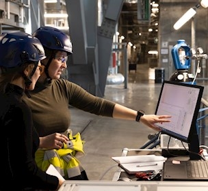Women pointing at a screen