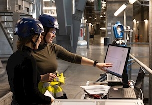 Women pointing at a screen
