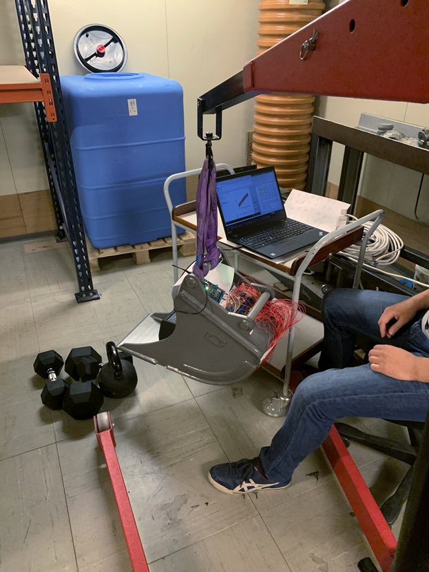 Testing in the lab. Fitness hand weights were used to simulate a large, bulky rock being picked up.