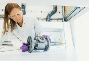 Woman assessing a component