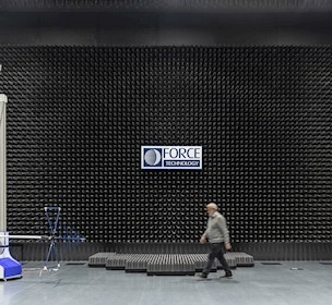 Man walking across large electromagnetic compatibility testing room