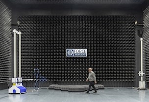 Man walking across large electromagnetic compatibility testing room