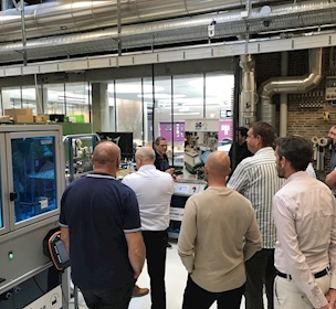 people standing in a production facility