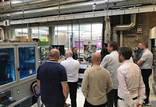 people standing in a production facility