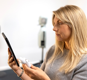 Blonde woman testing audio device