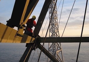 Man sitting on knees on structure